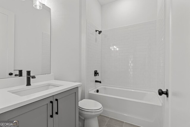 full bathroom with vanity, tile patterned flooring, toilet, and tiled shower / bath