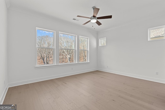 spare room featuring crown molding, ceiling fan, and light hardwood / wood-style flooring