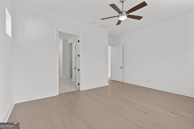 empty room featuring ornamental molding, ceiling fan, and light wood-type flooring