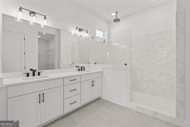 bathroom featuring a tile shower and vanity