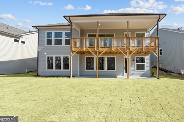 back of house with a patio and a lawn