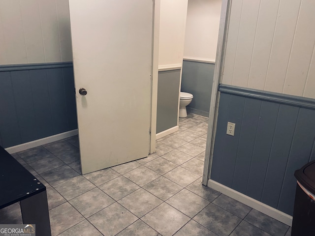 bathroom featuring tile patterned flooring and toilet