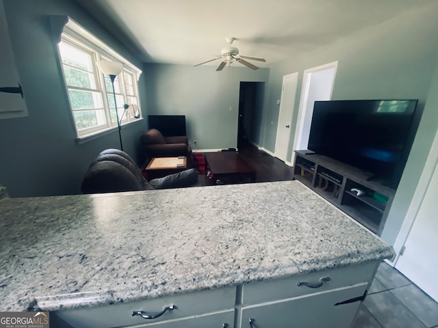 kitchen with ceiling fan and dark tile patterned flooring