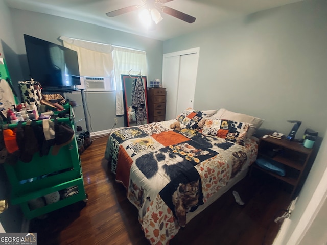 bedroom featuring dark hardwood / wood-style flooring, a closet, ceiling fan, and cooling unit