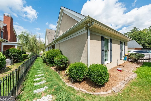 view of property exterior featuring a lawn