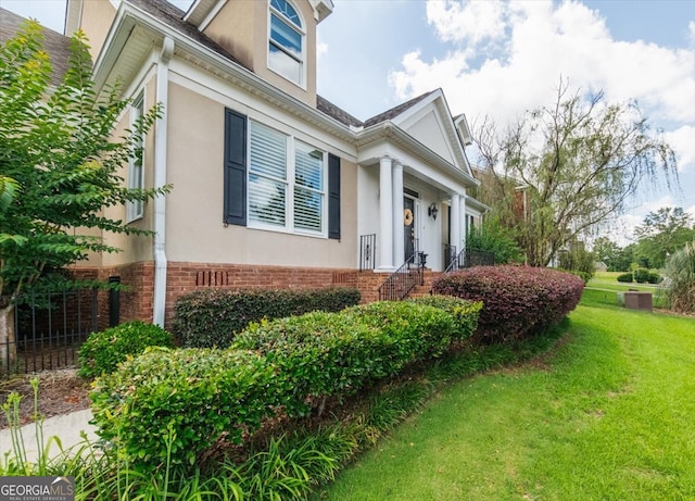 view of home's exterior with a yard