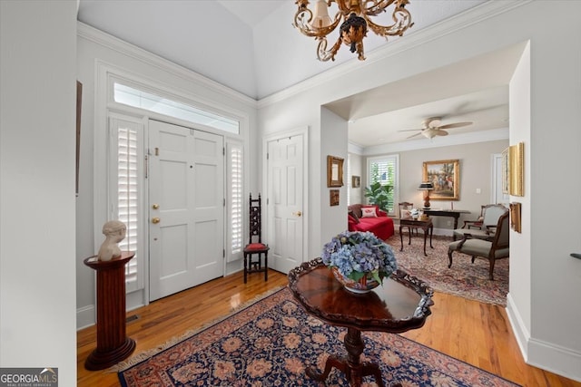 entryway featuring ceiling fan, crown molding, and hardwood / wood-style floors