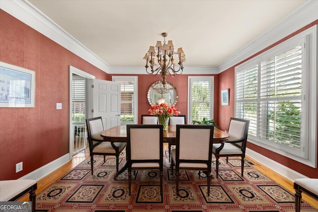 dining area with a chandelier, dark wood-type flooring, and crown molding