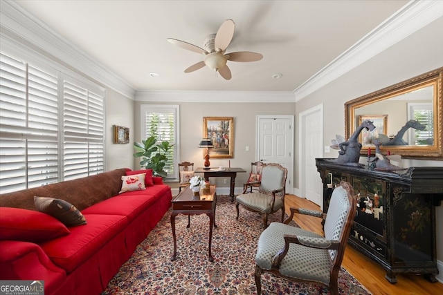 living room featuring light hardwood / wood-style flooring, ceiling fan, and ornamental molding