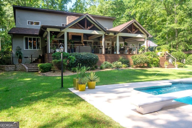 back of property with a patio area and a lawn