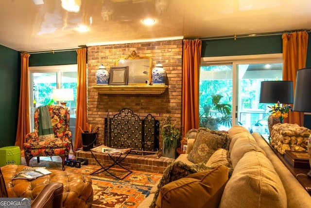 living room with a fireplace and brick wall