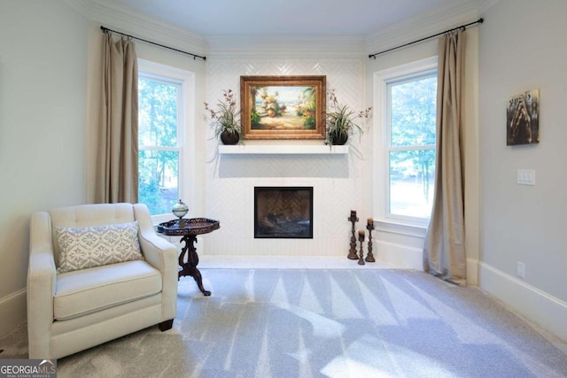 sitting room with carpet, a healthy amount of sunlight, and ornamental molding