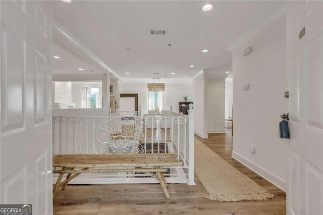 corridor with crown molding and hardwood / wood-style flooring