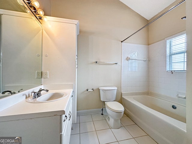 full bathroom with tile patterned floors, vanity, tiled shower / bath combo, and toilet