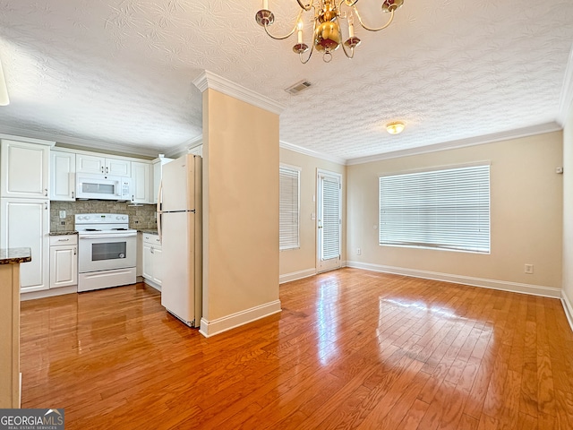 kitchen with white cabinetry, crown molding, white appliances, and light wood-type flooring