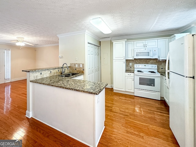 kitchen with white cabinetry, ceiling fan, white appliances, light hardwood / wood-style flooring, and kitchen peninsula