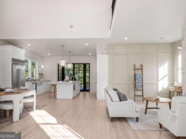 living room with a wealth of natural light and light wood-type flooring