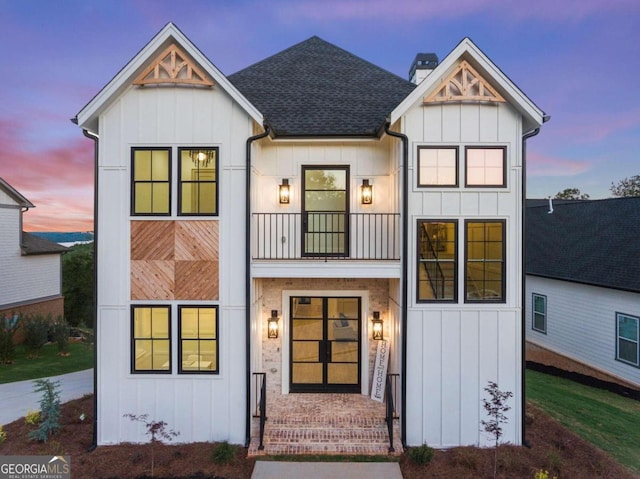 modern inspired farmhouse with a balcony