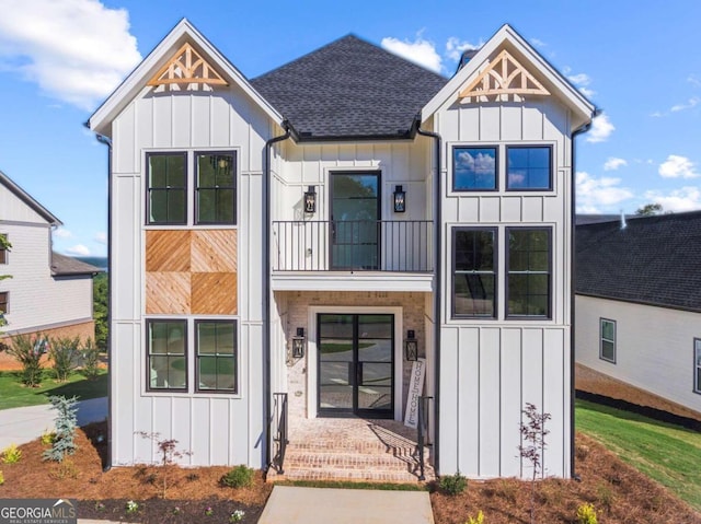 modern farmhouse style home featuring a balcony