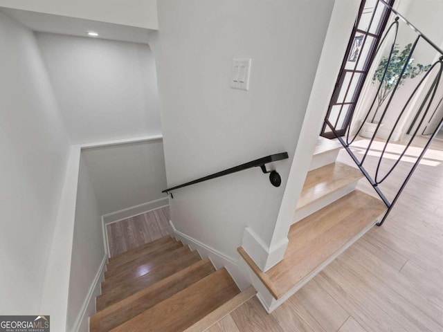 stairway featuring light wood-type flooring