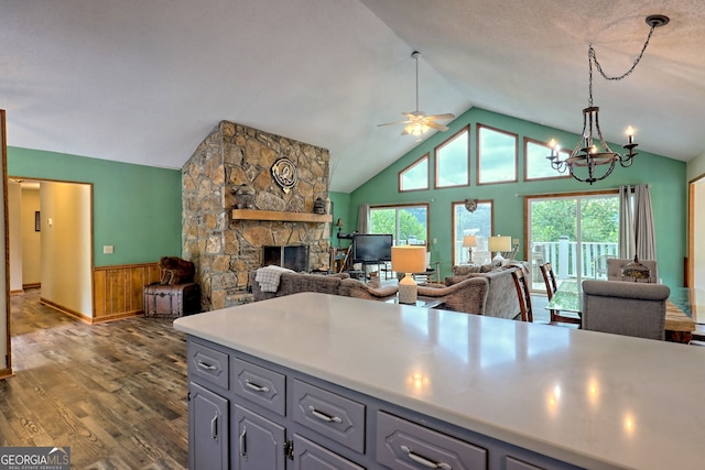 kitchen featuring a wealth of natural light, gray cabinetry, dark hardwood / wood-style floors, and a fireplace