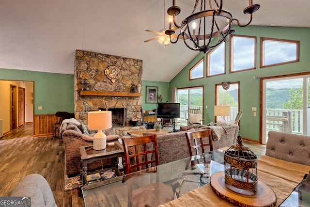 living room featuring a fireplace, hardwood / wood-style flooring, a chandelier, and a healthy amount of sunlight