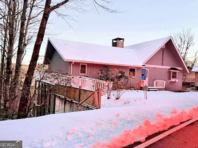 view of snow covered rear of property