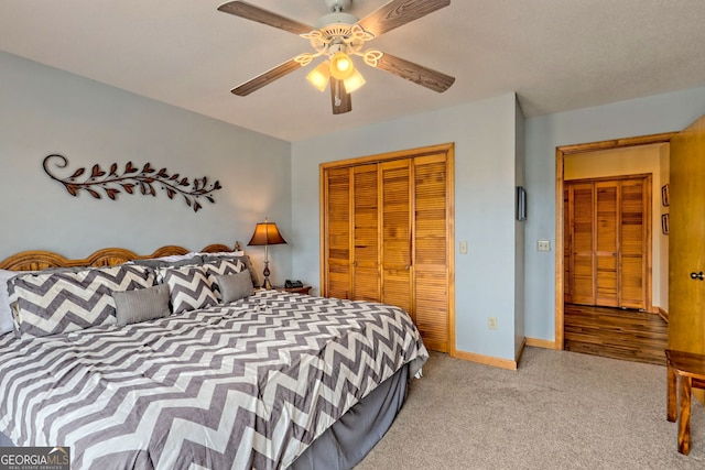 carpeted bedroom featuring ceiling fan and a closet