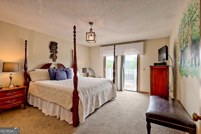 carpeted bedroom featuring a textured ceiling and access to exterior