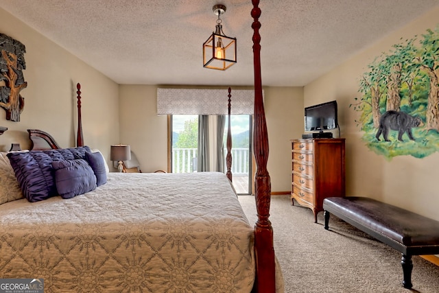 carpeted bedroom with access to outside and a textured ceiling