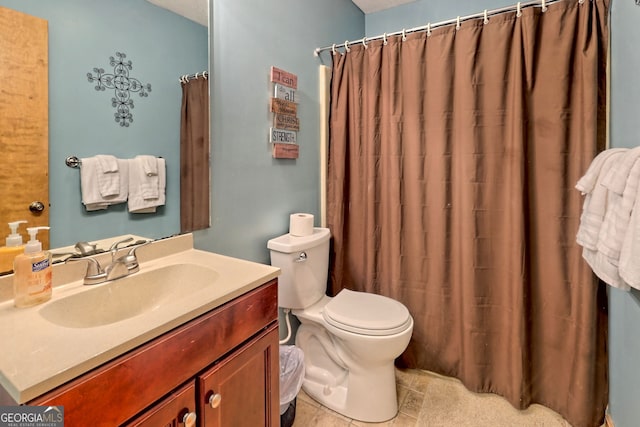 bathroom with toilet, vanity, and a shower with curtain