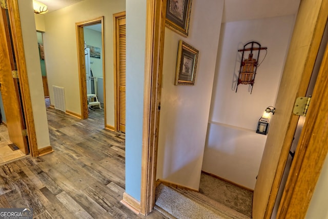 hallway with wood-type flooring