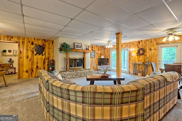 living room featuring ceiling fan, carpet flooring, and a healthy amount of sunlight