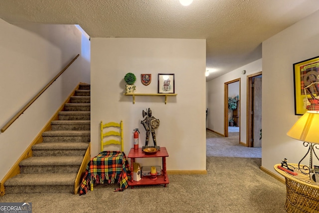 interior space featuring carpet floors and a textured ceiling