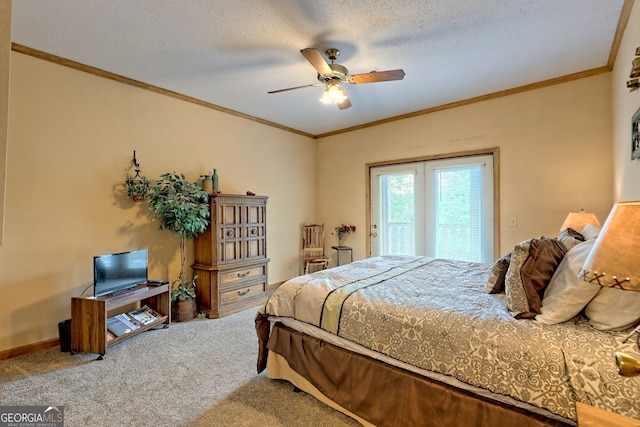 carpeted bedroom featuring a textured ceiling, ornamental molding, and ceiling fan