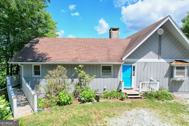 rear view of house with a yard