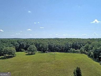 birds eye view of property with a rural view