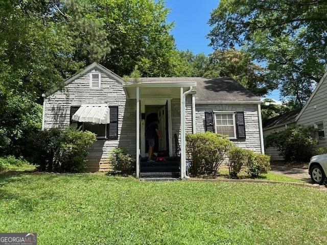 bungalow-style home with a front lawn