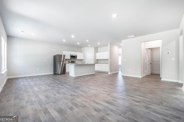 unfurnished living room with wood-type flooring