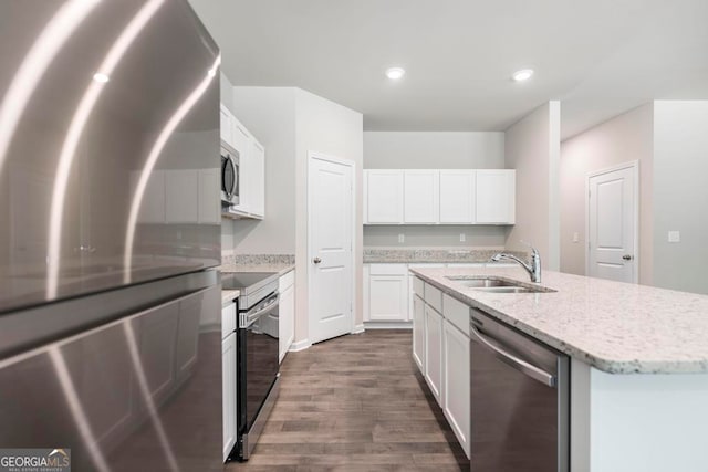 kitchen featuring white cabinetry, dark hardwood / wood-style floors, light stone countertops, appliances with stainless steel finishes, and sink