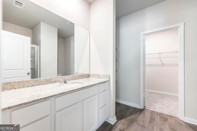 bathroom featuring vanity and hardwood / wood-style flooring