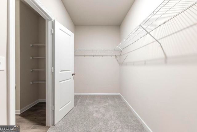 spacious closet featuring hardwood / wood-style floors