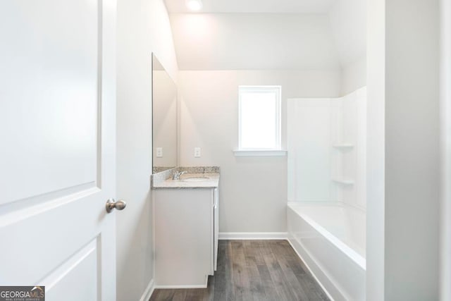 bathroom with vanity, bathtub / shower combination, and hardwood / wood-style floors