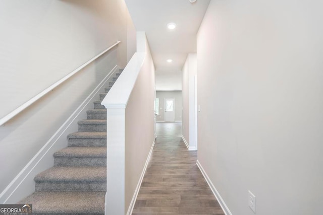 stairs featuring hardwood / wood-style flooring