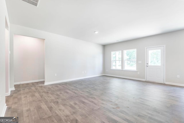 unfurnished room with hardwood / wood-style floors