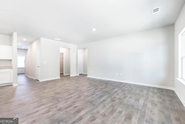 unfurnished living room featuring hardwood / wood-style flooring