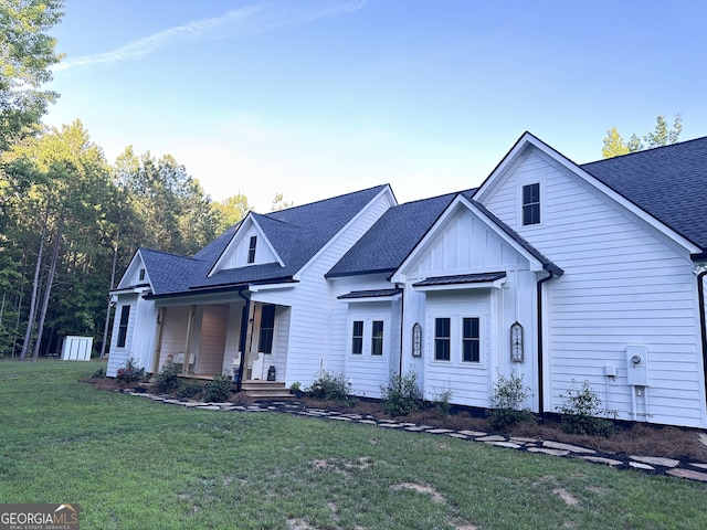 view of front of house with a porch and a front lawn