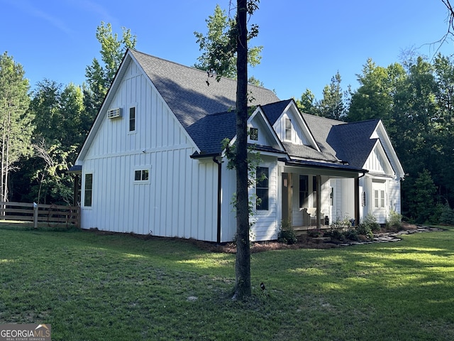 view of home's exterior featuring a wall mounted air conditioner and a yard