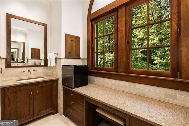 bathroom with decorative backsplash and vanity