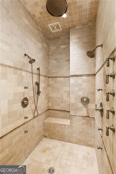 bathroom with a tile shower